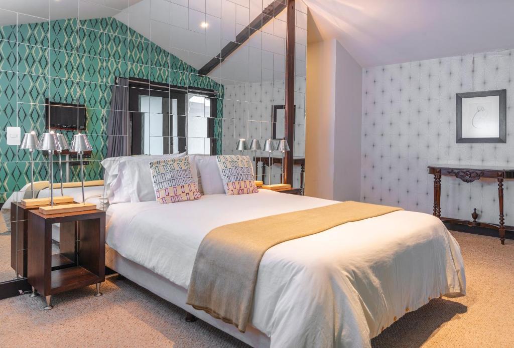 Postel nebo postele na pokoji v ubytování Hotel Casa Gardenia