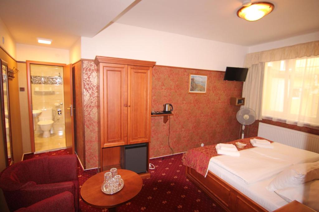 a hotel room with a bed and a chair at Old Prague Hotel in Prague