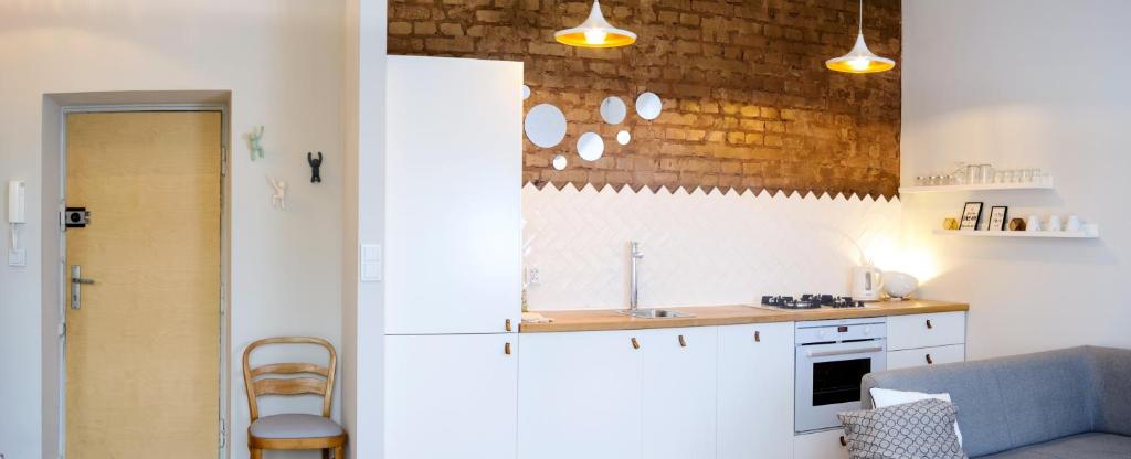 a kitchen with a sink and a counter top at Zoli Apartment in Warsaw