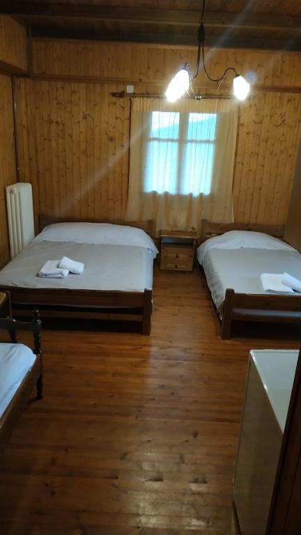 a room with two beds and a window in it at Athamania Artas in Athamanio