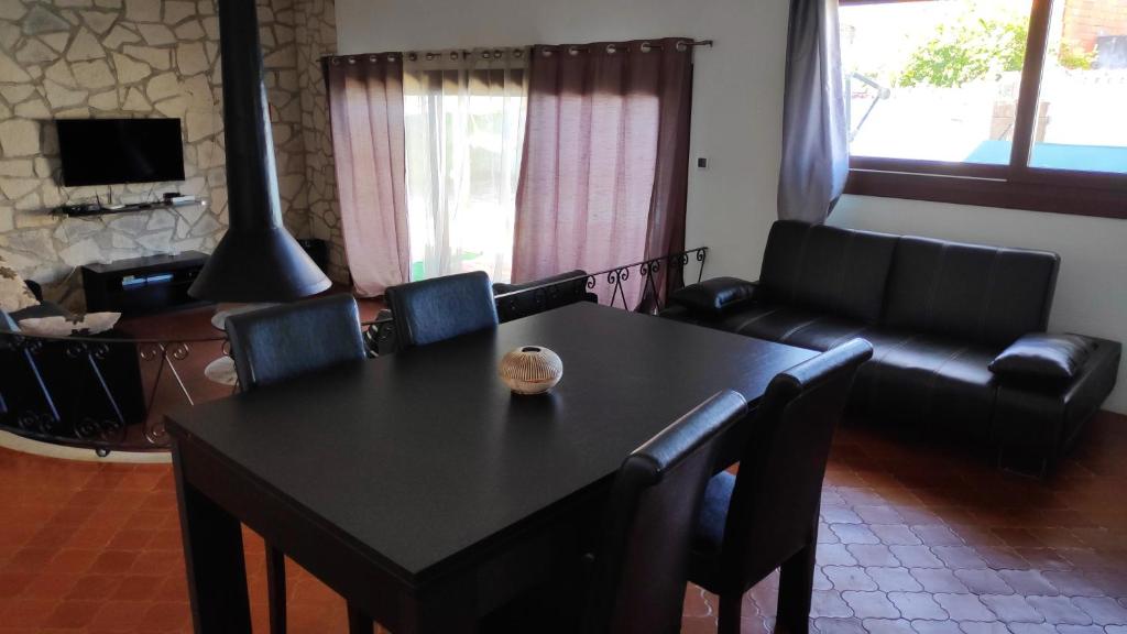 a living room with a table and chairs and a couch at Louro's Villa - 12130AL in Cantanhede