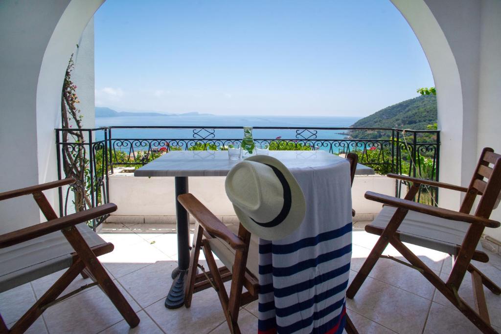 a hat sitting on a table on a balcony at Spiros Studios in Parga