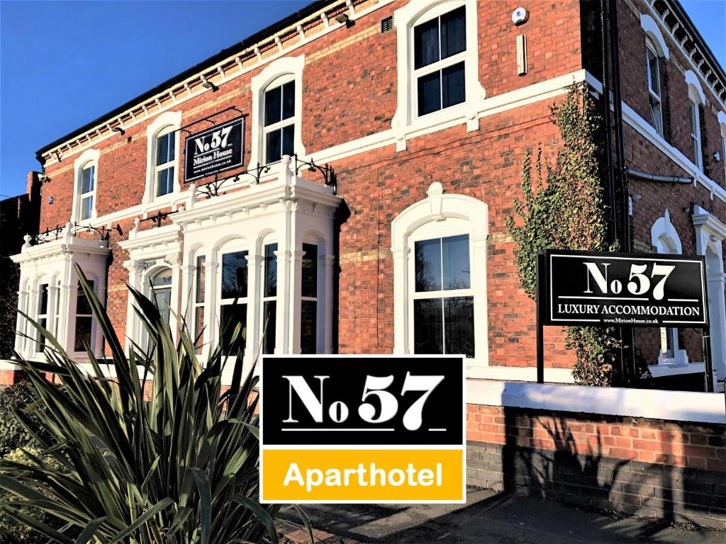 a brick building with two street signs in front of it at No57 in Crewe