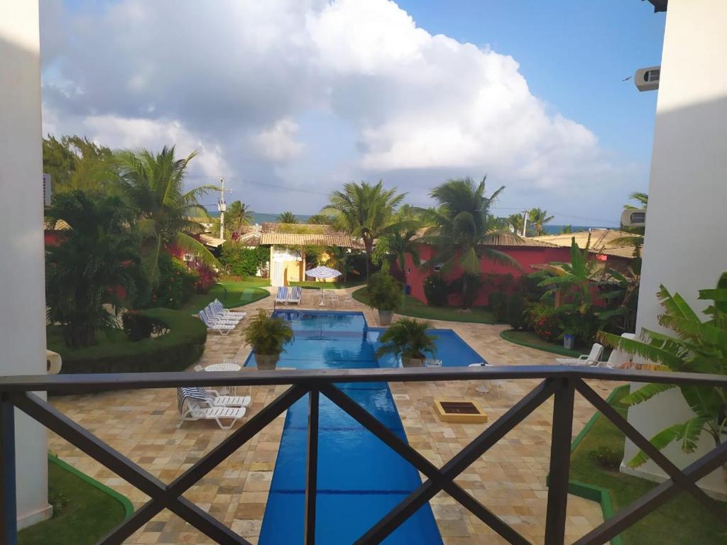 a view of the pool from the balcony of a resort at Condominio Arituba Tropical in Nísia Floresta