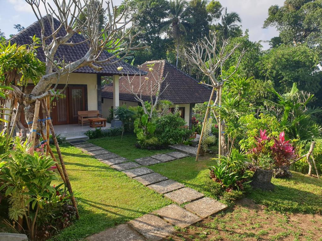 a house with a garden with a pathway leading to it at Rumah Sidemen in Sidemen