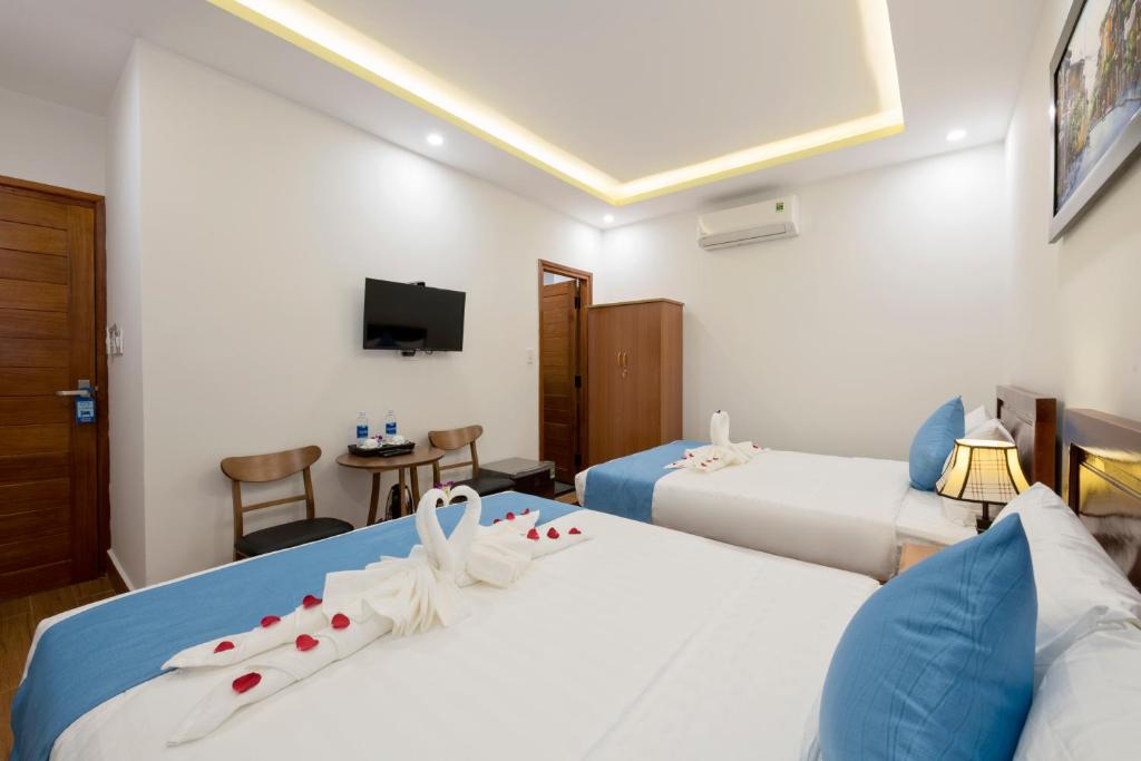 Postel nebo postele na pokoji v ubytování Hoi An Impression Homestay