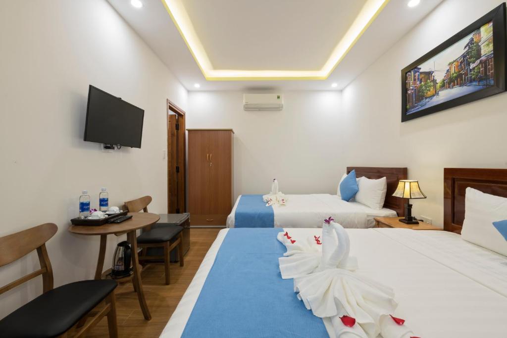 Postel nebo postele na pokoji v ubytování Hoi An Impression Homestay