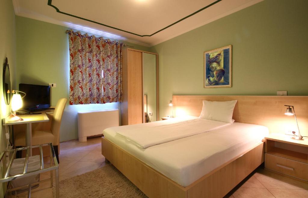 Postel nebo postele na pokoji v ubytování Hotel Aruba