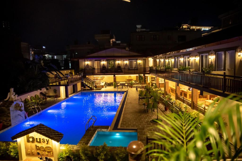 a view of a swimming pool at night at Busy Bee Resort, Pokhara in Pokhara