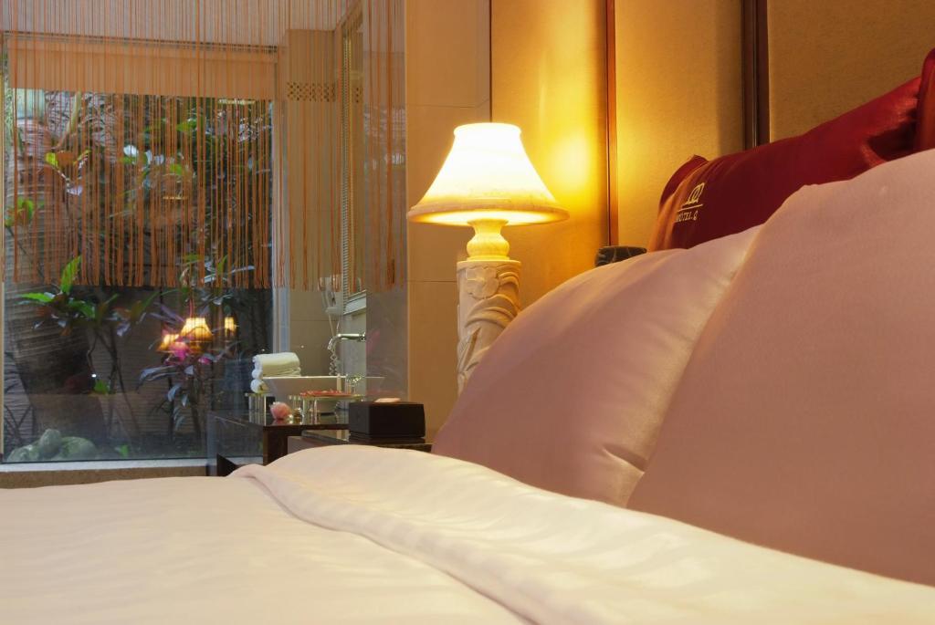 Postel nebo postele na pokoji v ubytování Q Motel精品旅館