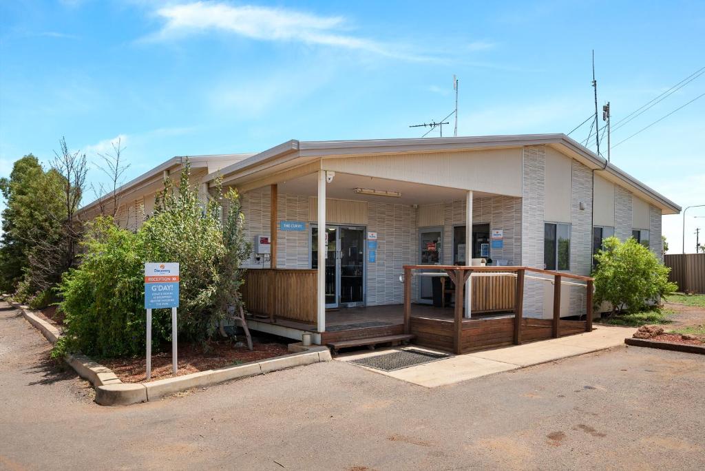 a small white building with a sign in front of it at Discovery Parks - Cloncurry in Cloncurry