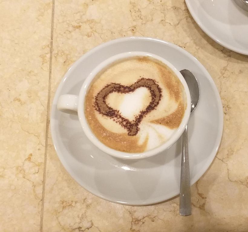 a cup of coffee with a heart drawn on it at Hotel Corallo in Francavilla al Mare