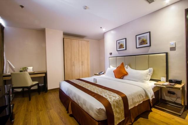 Postel nebo postele na pokoji v ubytování ACE Hotel and Suites