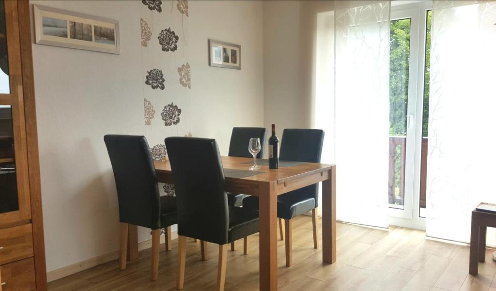 a dining room table with black chairs around it at Ferienwohnung Rothaarsteig in Winterberg-Neuastenberg in Winterberg