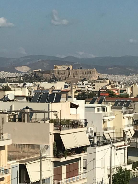 a cityscape of buildings with the acropolis in the background at Acropolis View in Athens