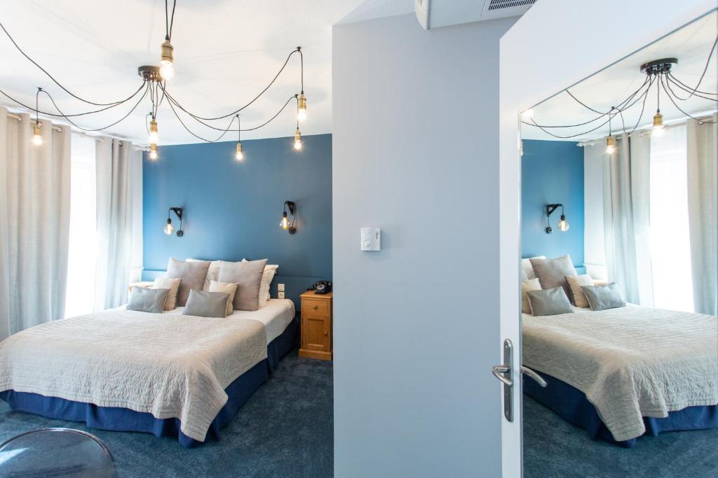 Postel nebo postele na pokoji v ubytování Hôtel Le Rapp