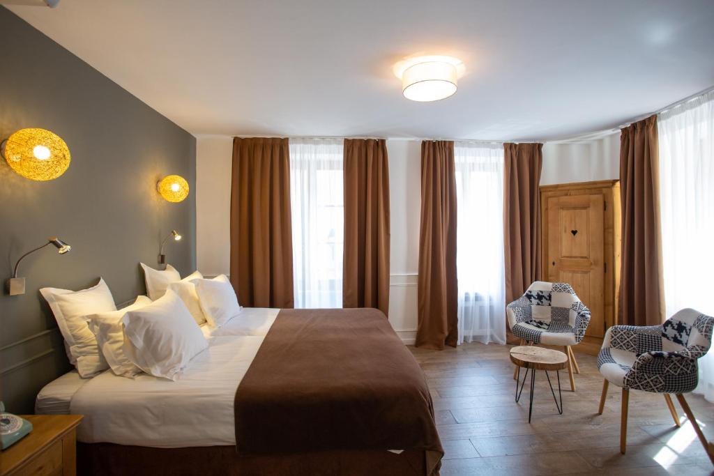Postel nebo postele na pokoji v ubytování Hôtel Le Rapp