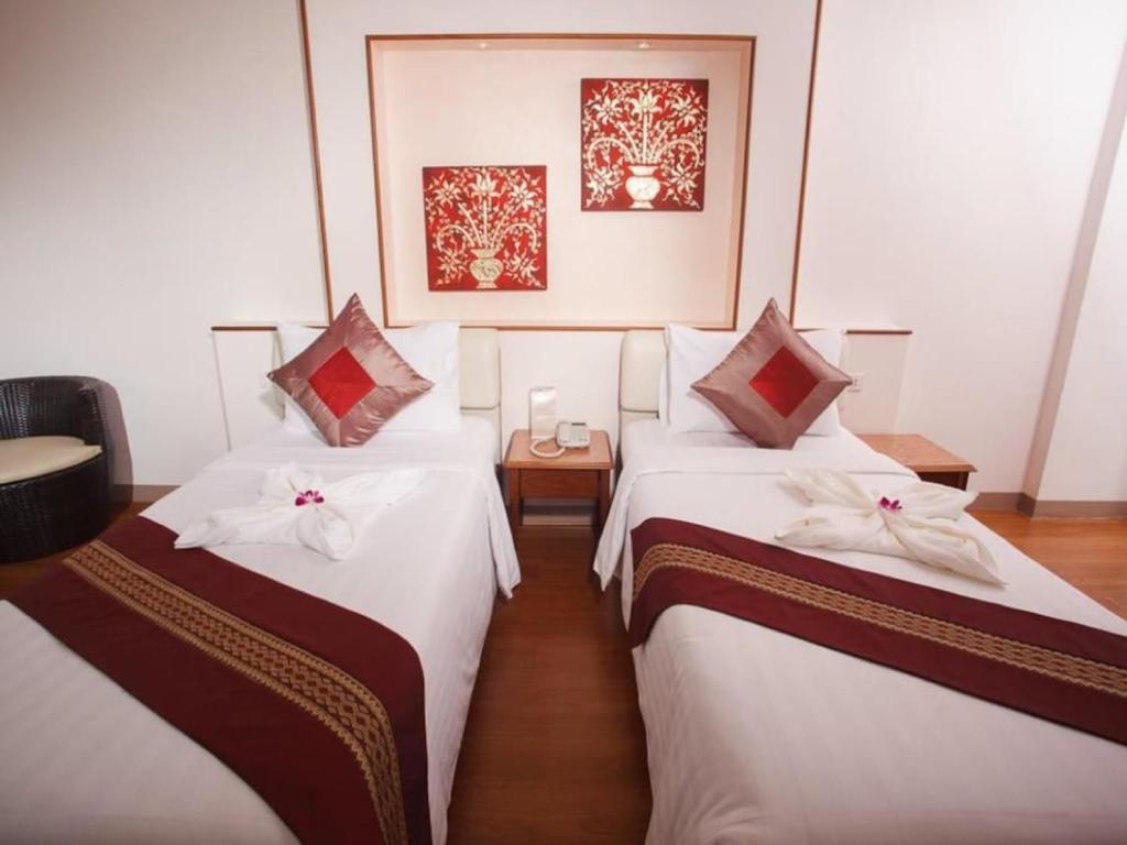 Postel nebo postele na pokoji v ubytování KC Place Hotel Pratunam