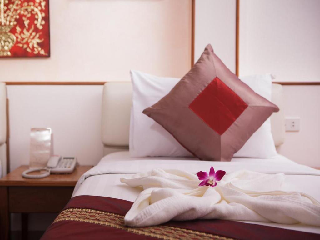 Postel nebo postele na pokoji v ubytování KC Place Hotel Pratunam