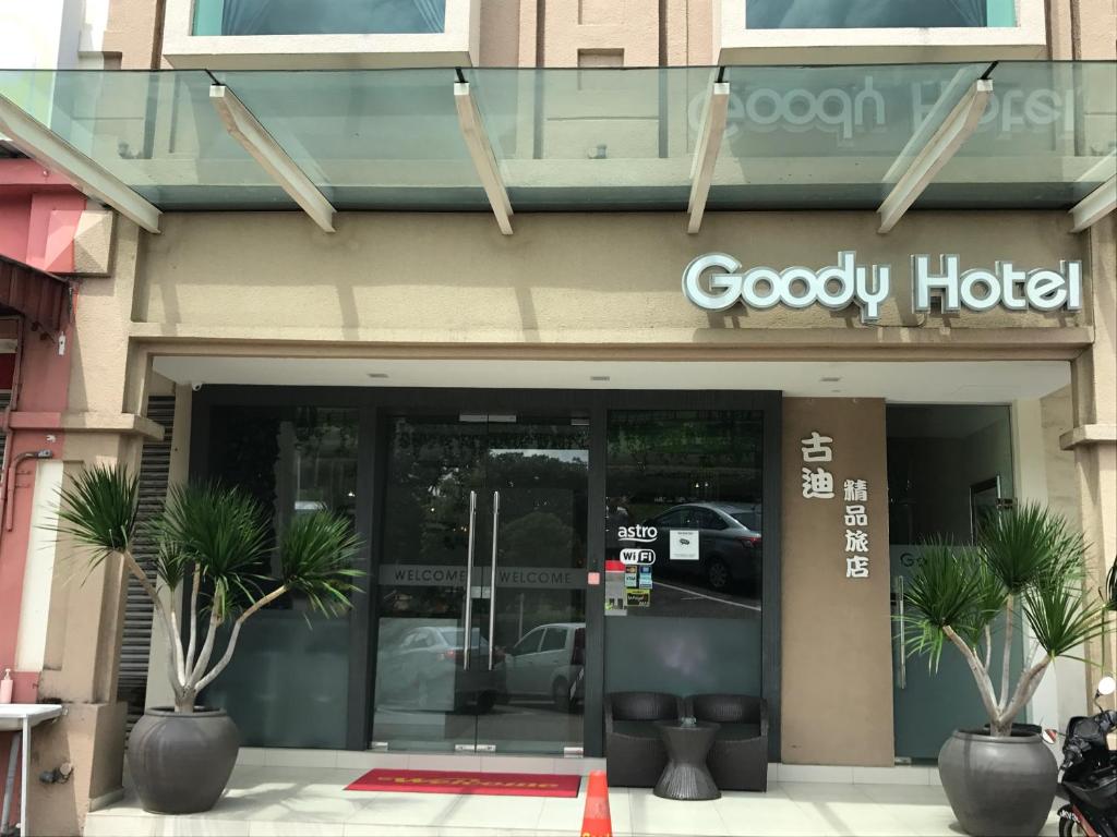 a godfrey hotel entrance with palm trees in front of it at GOODY HOTEL in Johor Bahru