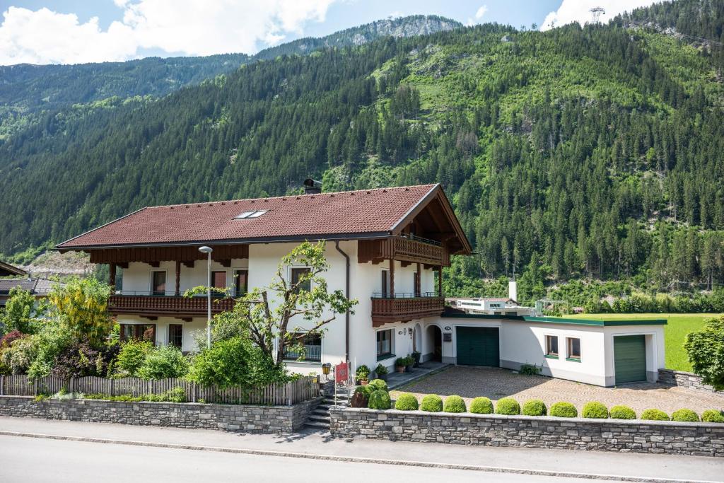 una casa con una montaña en el fondo en Landhaus Tyrol en Mayrhofen