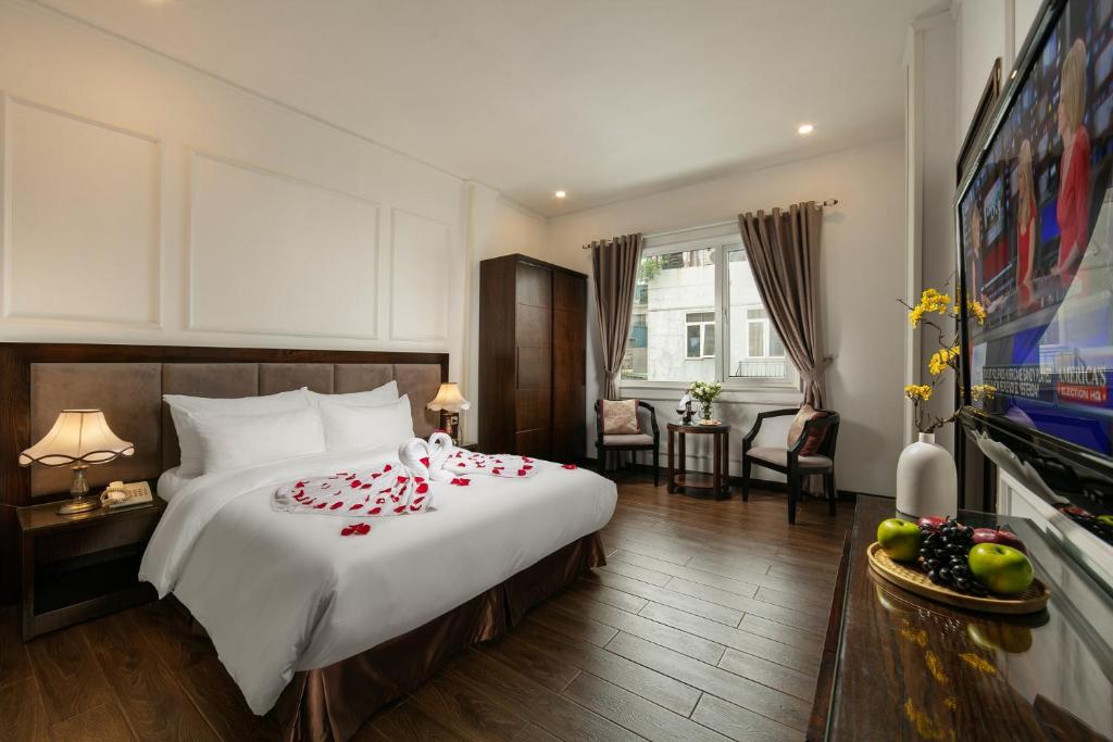 a hotel room with a bed with candy canes on it at Hong Ngoc Cochinchine Boutique Hotel & Spa in Hanoi