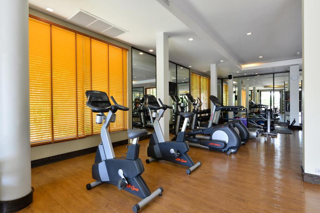 a gym with several treadmills and elliptical machines at Layana Resort & Spa - SHA Extra Plus in Ko Lanta