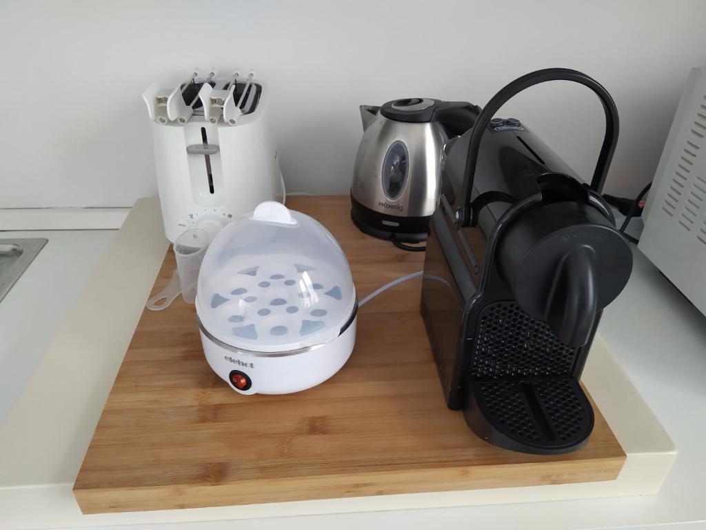 a kitchen counter with a mixer and a coffee maker at La mansarda sul Porto in Camogli