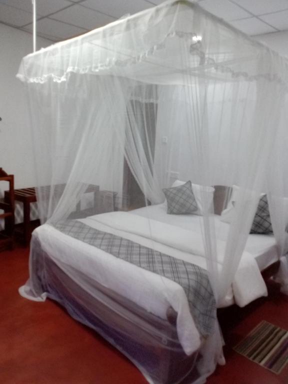 Postel nebo postele na pokoji v ubytování Samiru Guest Inn Ella