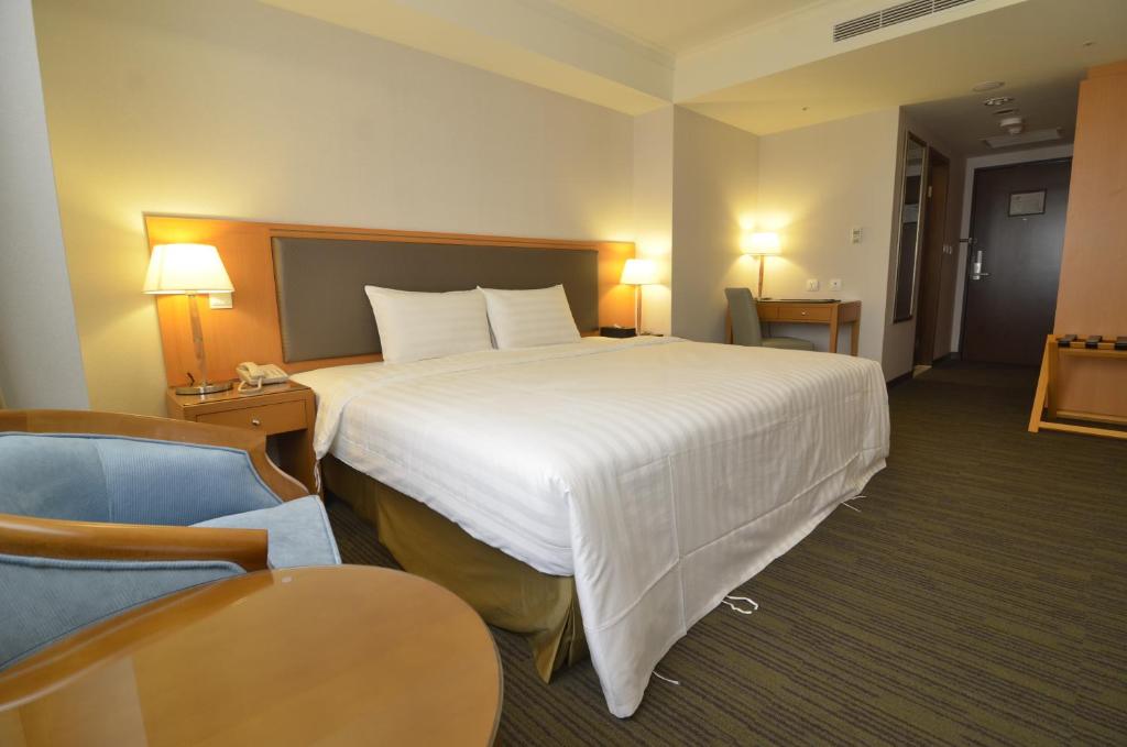 Postel nebo postele na pokoji v ubytování Fuward Hotel Tainan