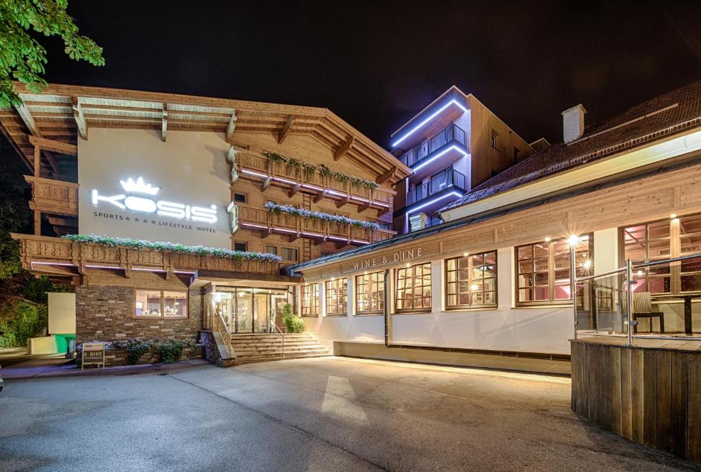 an exterior view of a building at night at KOSIS Sports Lifestyle Hotel in Fügen