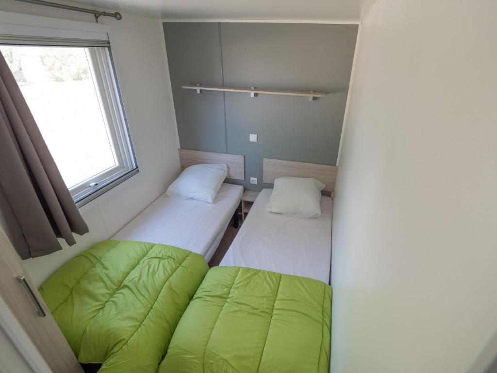 Cama o camas de una habitación en Camping L'Orangeraie
