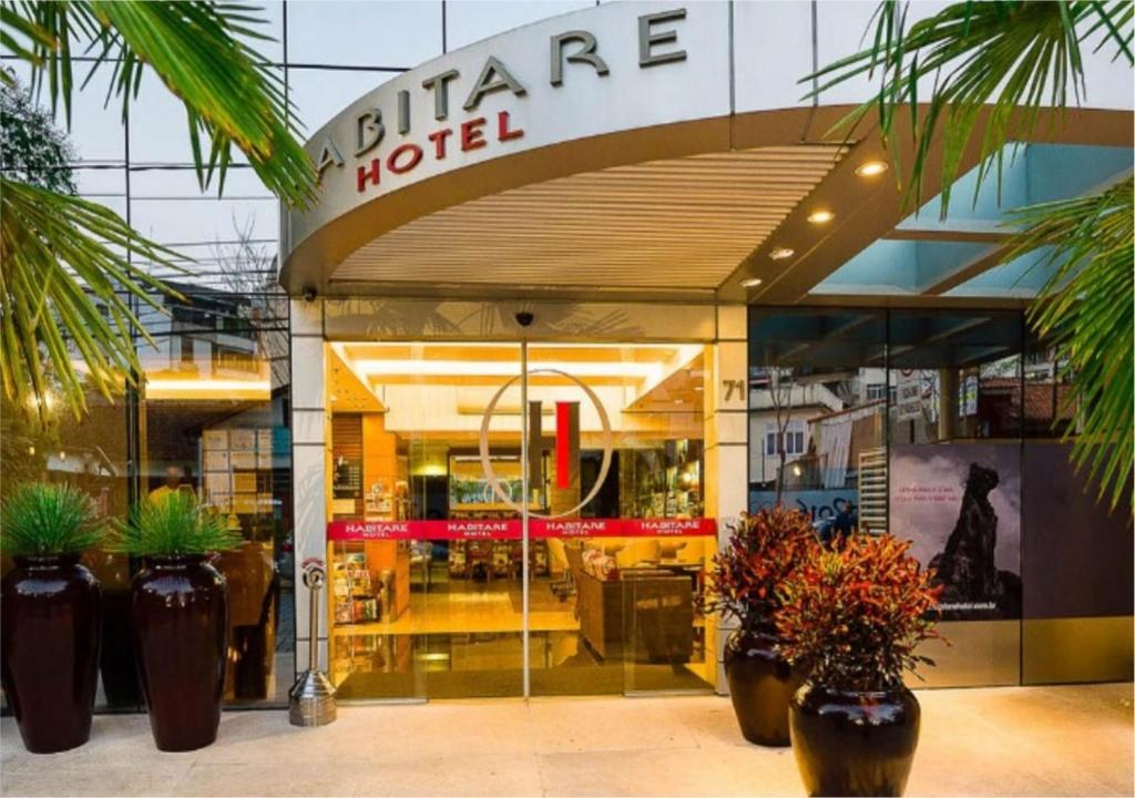 a store front with potted plants in front of it at Hotel Habitare in Nova Friburgo