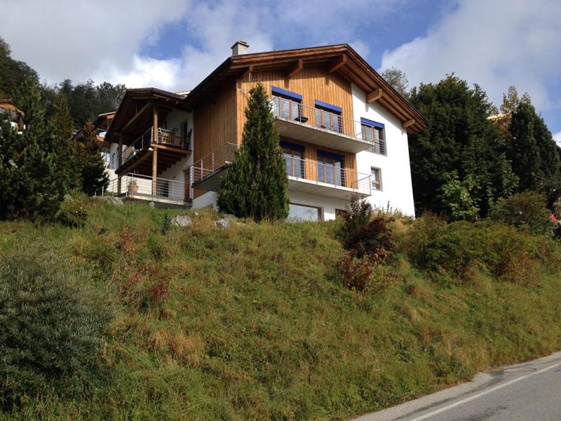 a house on the side of a hill at Principala 5 Zeller Andiast - Ferienwohnung für max. 10 Personen in Andest