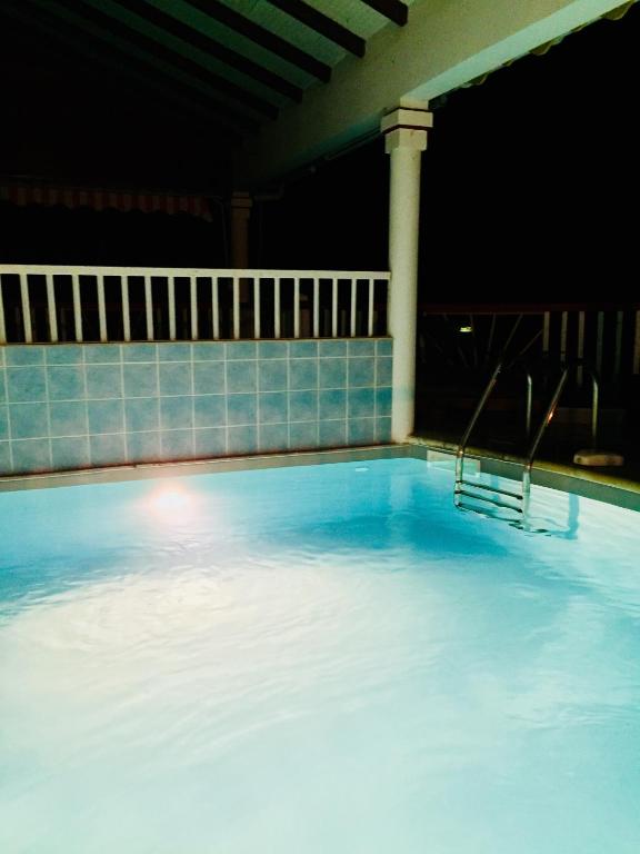 a large pool of water with a pillar in it at Le Saintois in Terre-de-Bas