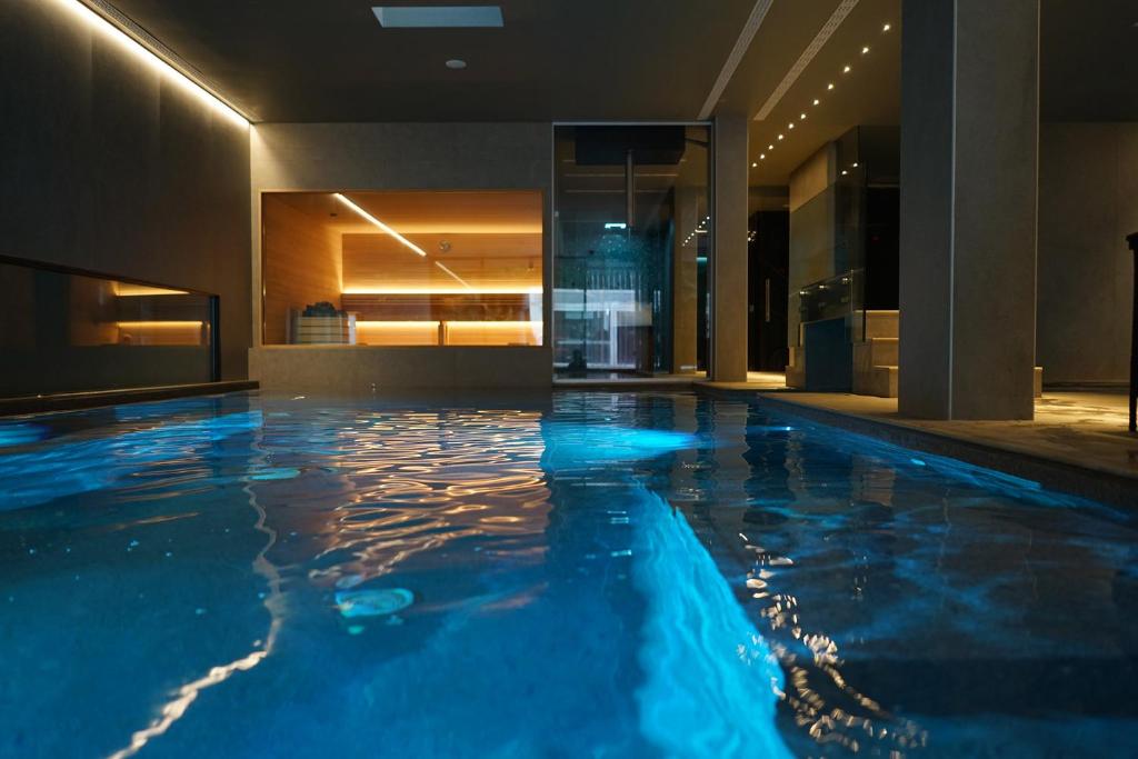 a swimming pool in a hotel with blue lighting at Atlantic Park Hotel in Fiuggi
