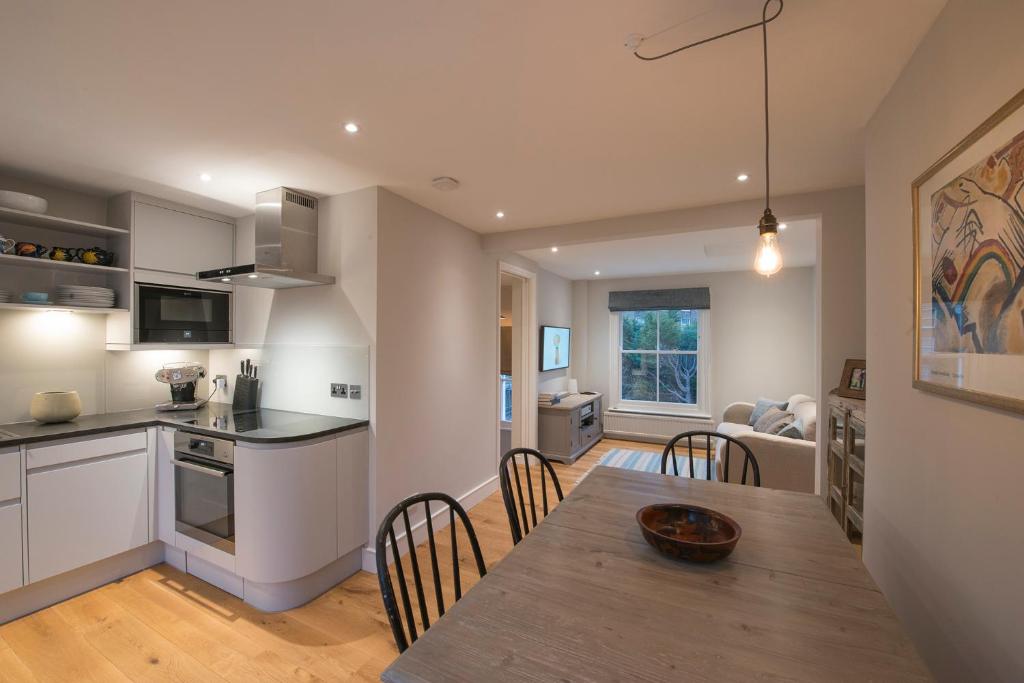 a kitchen and dining room with a table and chairs at Waterloo Sunset in London