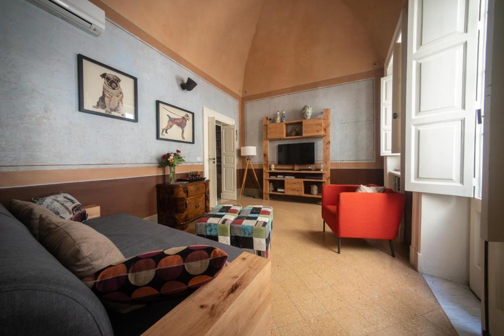 a living room with a bed and a television at La Cartapesta in Lecce