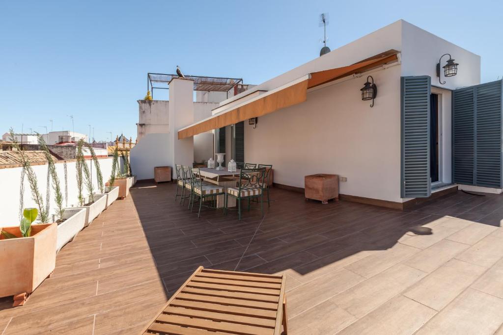 a balcony with a table and chairs on a building at Atico de lujo en Aguilas in Seville