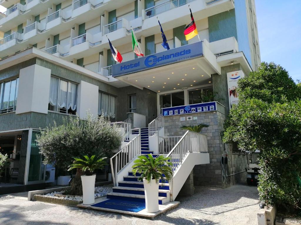 a hotel with stairs in front of a building at Hotel Esplanade in Cesenatico