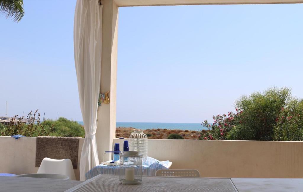 a room with a table and a view of the ocean at Terrazza Anticaglie in Punta Braccetto