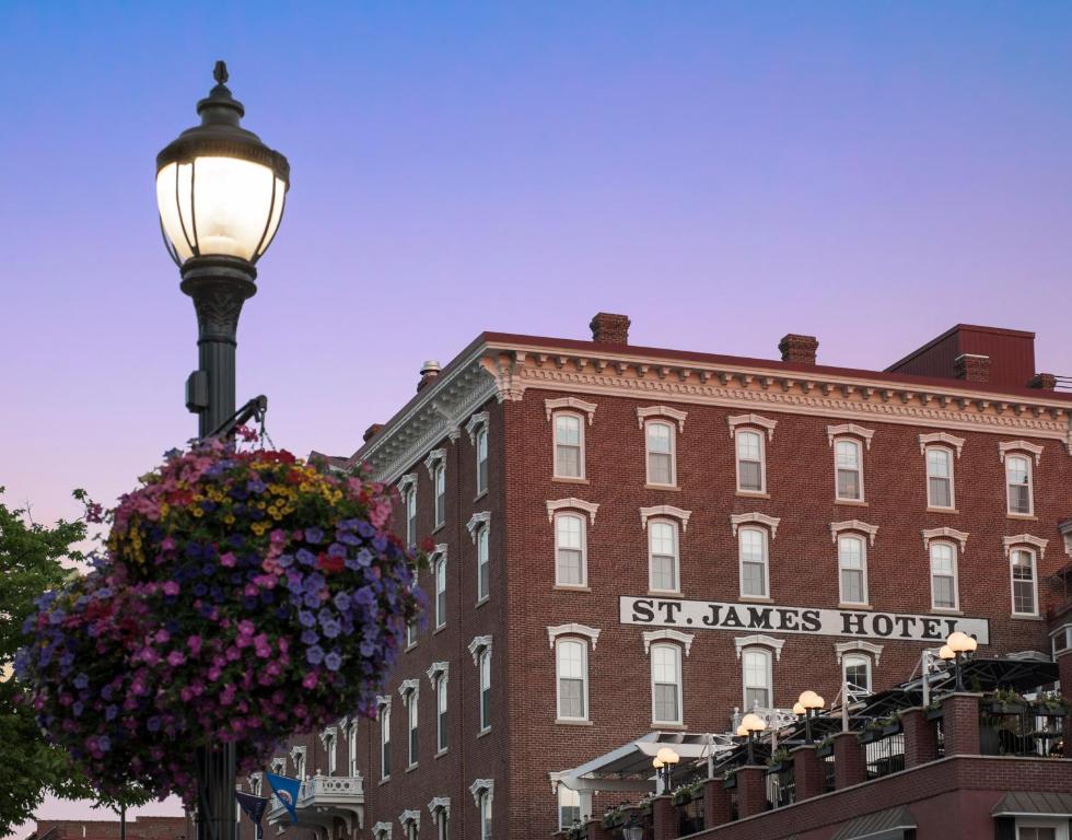 a street light with a basket of flowers in front of a building at St James Hotel in Red Wing