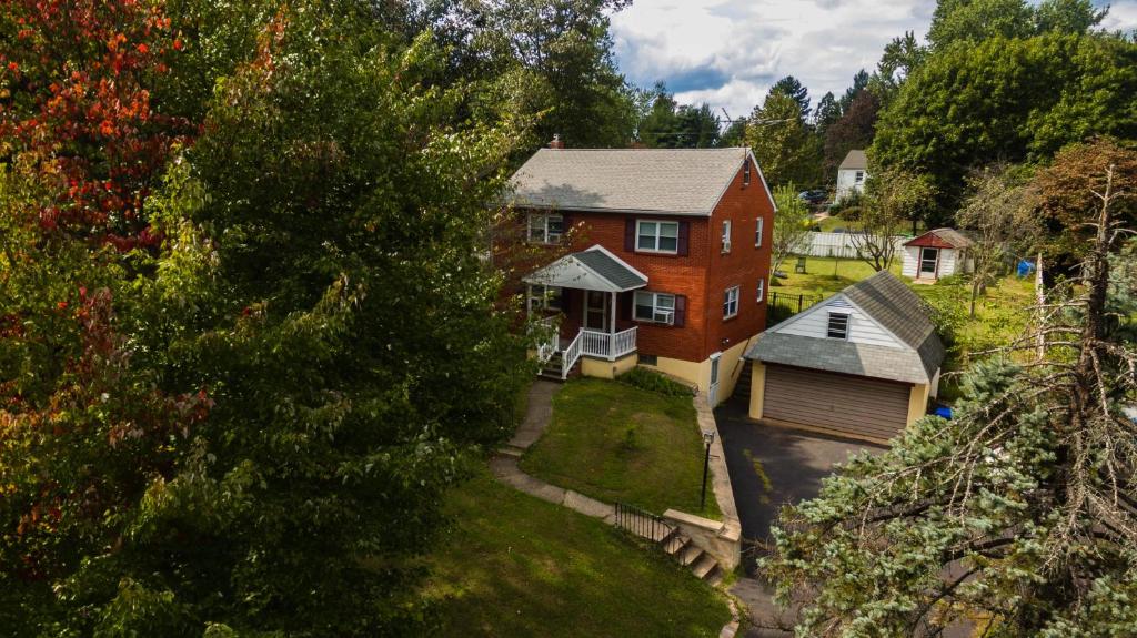 an aerial view of a red house with a garage at Red brick house in Chalfont