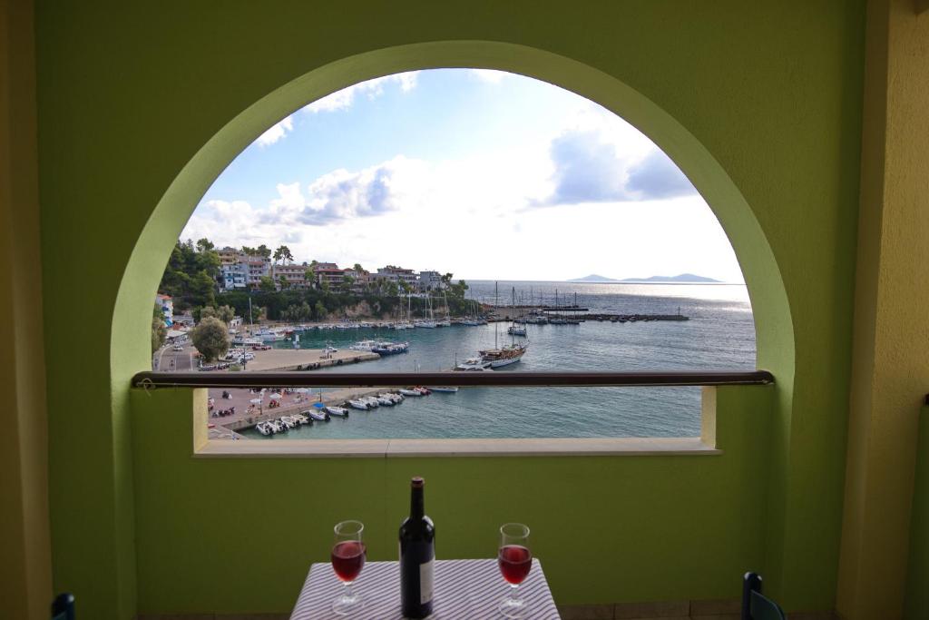 a window with a view of a body of water at Haravgi Hotel in Patitiri