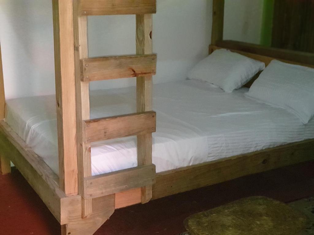 Postel nebo postele na pokoji v ubytování Ti Kwen Glo Cho