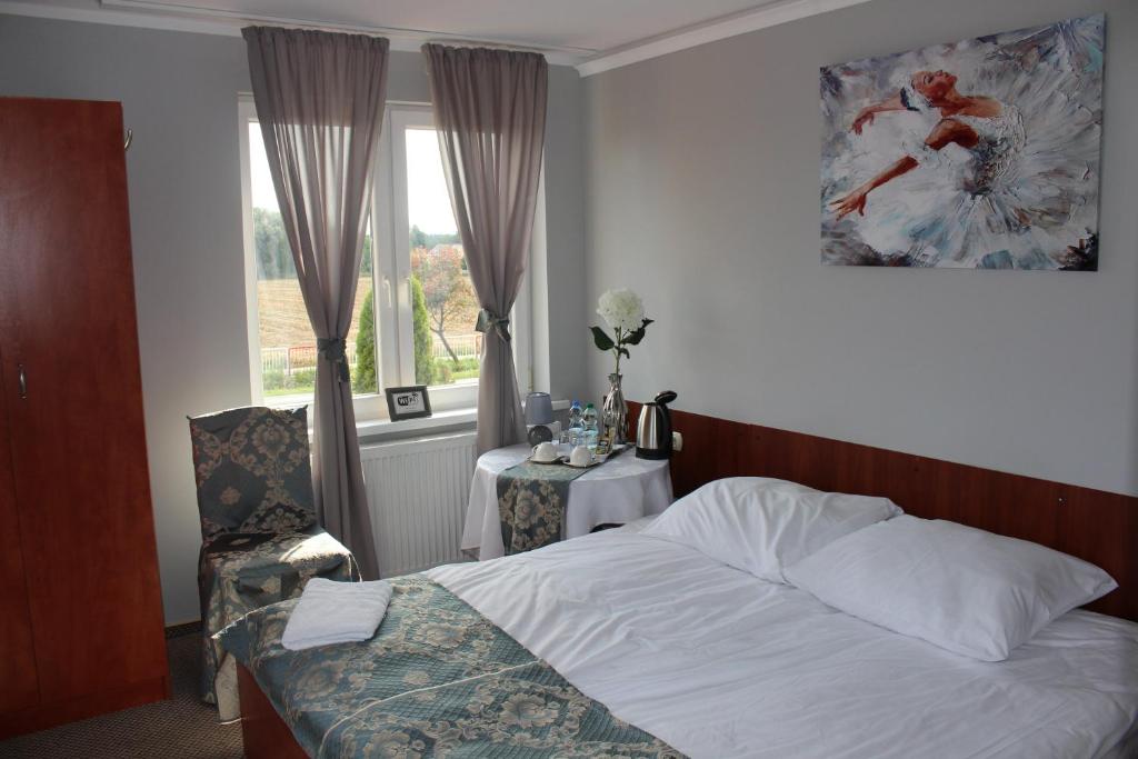 Posteľ alebo postele v izbe v ubytovaní Restauracja Hotel Kassandra