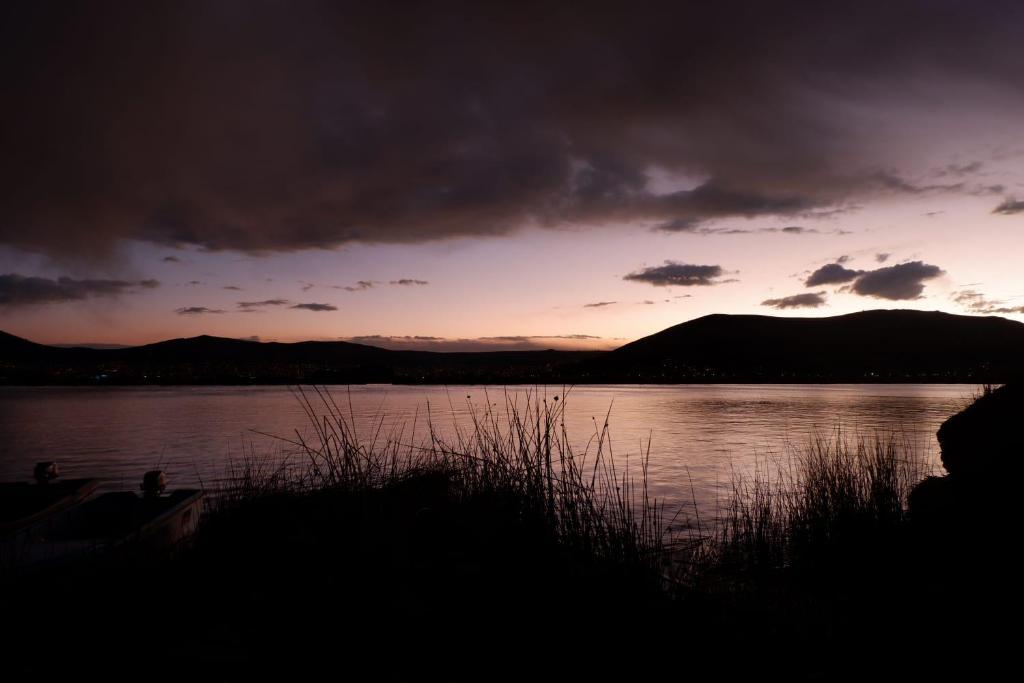 a sunset over a large body of water at Uros Casa de Yolanda in Puno