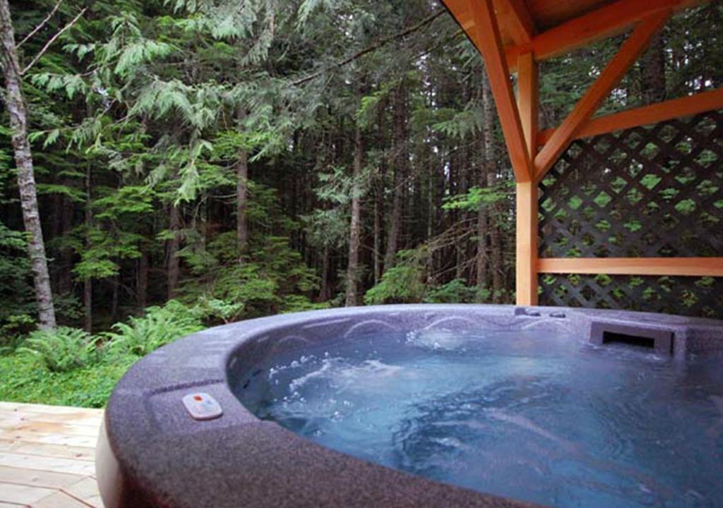 a hot tub in a gazebo in the woods at Stormking Hotel in Ashford