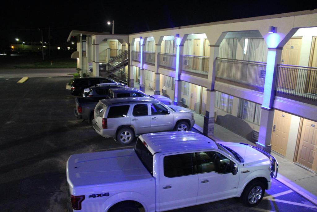a white truck parked in front of a building at Hutchinson Inn in Hutchinson