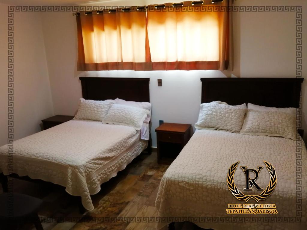 Postel nebo postele na pokoji v ubytování Hotel Real Victoria